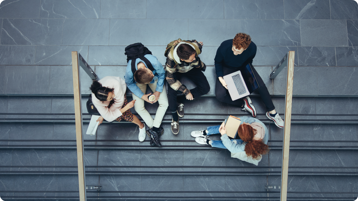 A group of tertiary students sitting together on a staircase